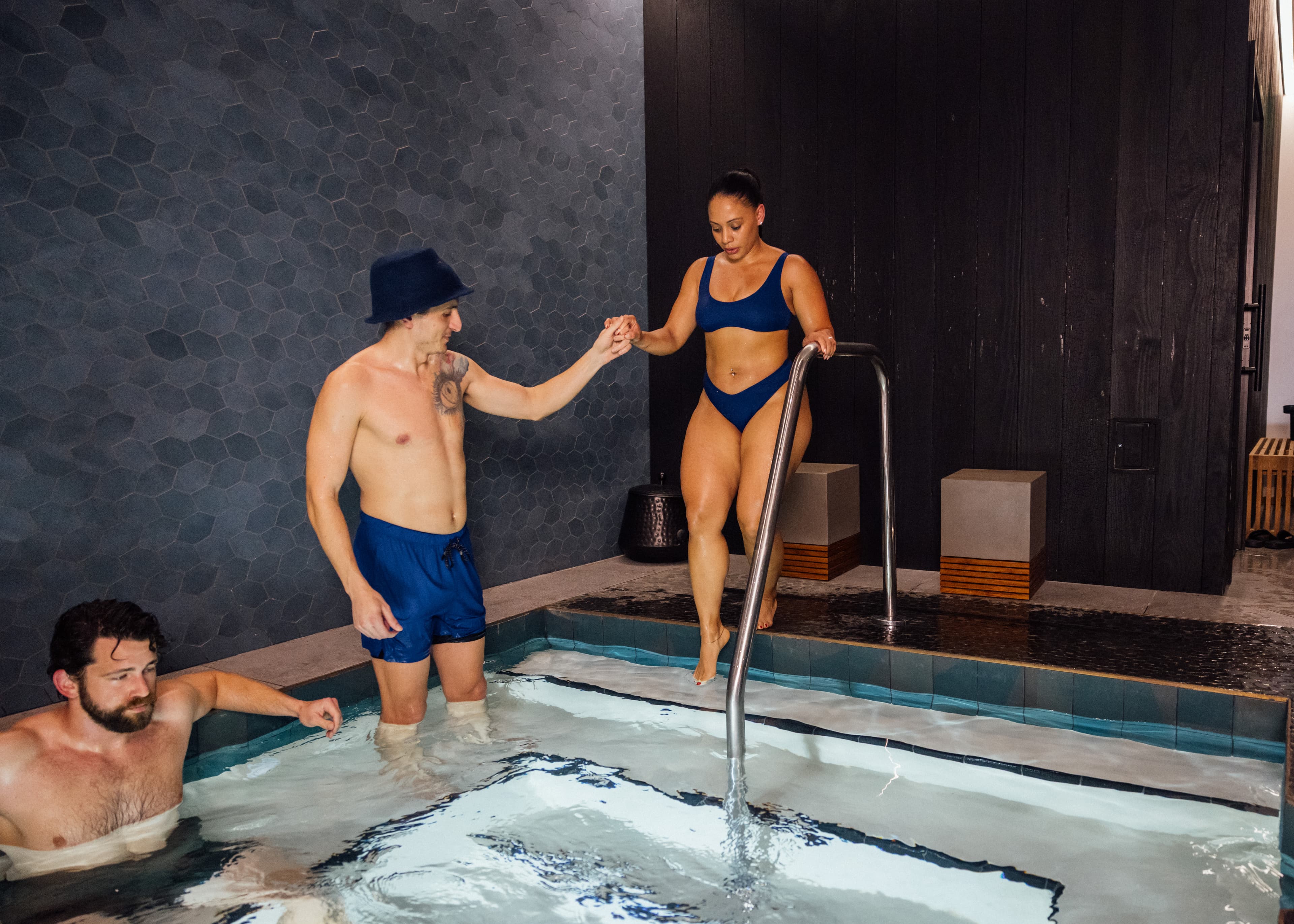 A couple moving together between the sauna and cold plunge at Revivery